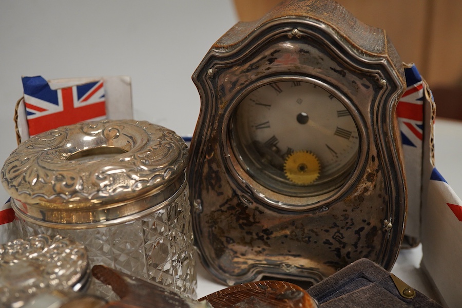 A collection of sundry silver items to include a silver mounted timepiece, hexagonal pill box and photo frames, one housing a hand painted porcelain portrait plaque, largest 12cm high